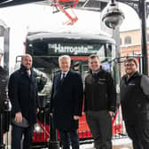Buses Minister Richard Holden (second left) in wintry weather at Harrogate Bus Station with (from left) Transdev Operations Director Vitto Pizzuti; Harrogate and Knaresborough MP Andrew Jones; Transdev Commercial Manager Matt Burley; and Network Manager Alex Spencer.