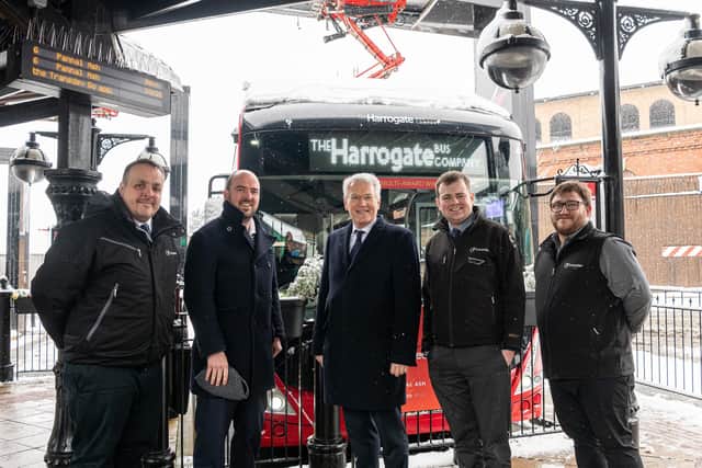 Buses Minister Richard Holden (second left) in wintry weather at Harrogate Bus Station with (from left) Transdev Operations Director Vitto Pizzuti; Harrogate and Knaresborough MP Andrew Jones; Transdev Commercial Manager Matt Burley; and Network Manager Alex Spencer.