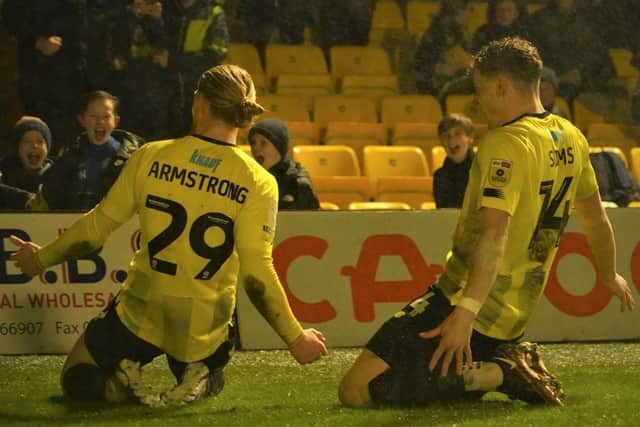 Harrogate Town striker Luke Armstrong, left, celebrates his 11th goal of the season with team-mate Toby Sims.
