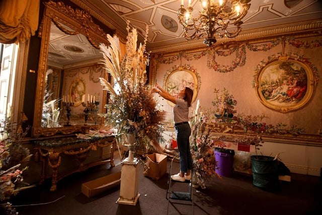Wendy Naylor busy arranging flowers and putting the finishing touches to a display in the house at Newby Hall