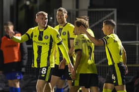 Dean Cornelius celebrates with his Harrogate Town team-mates after netting the only goal of the game during Friday night's FA Cup win over Gainsborough Trinity. Pictures: Matt Kirkham