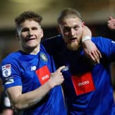 Toby Sims, left, congratulates team-mate Luke Armstrong after he gave Harrogate Town an 81st-minute lead at Doncaster Rovers on Tuesday evening. Pictures: Matt Kirkham