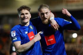 Toby Sims, left, congratulates team-mate Luke Armstrong after he gave Harrogate Town an 81st-minute lead at Doncaster Rovers on Tuesday evening. Pictures: Matt Kirkham