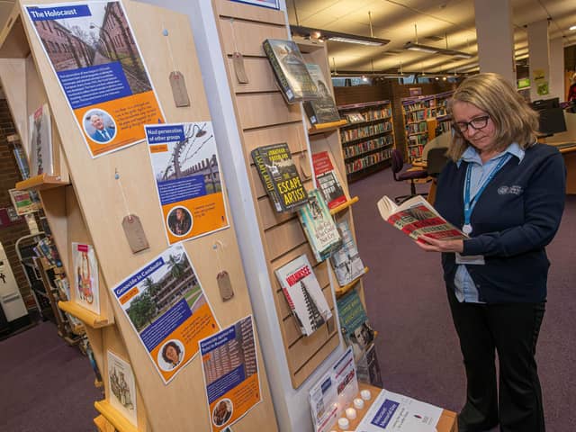 North Yorkshire libraries’ library assistant, Jo Madgwick, looks over the Holocaust Memorial Day display at Northallerton Library.