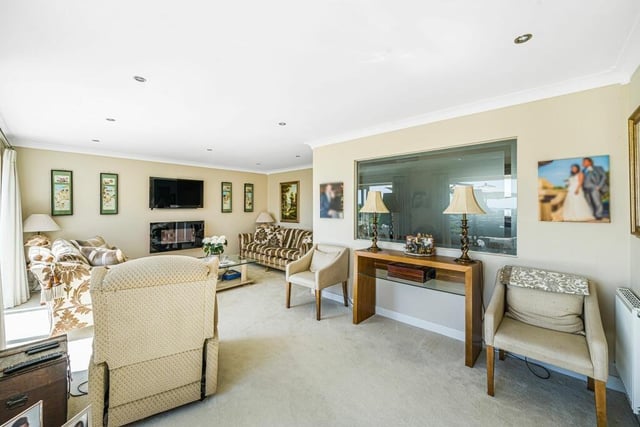 The bright and spacious lounge has sliding doors out to the garden.