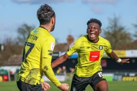 Harrogate Town midfielder Levi Sutton, left, celebrates his stoppage-time equaliser against AFC Wimbledon with team-mate Kazeem Olaigbe. Picture: Matt Kirkham