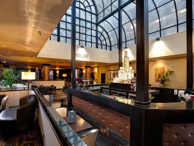 Light fantastic Atrium Bar & Restaurant beckons as President Hotel's beating heart.