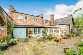 A view of the property with its enclosed front courtyard garden.