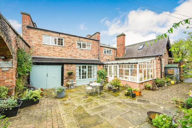 A view of the property with its enclosed front courtyard garden.