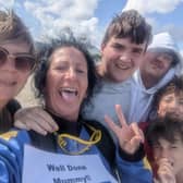 She was cheered on by her four sons as she made the 14,000ft jump to raise money for cancer research