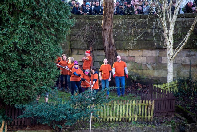 The orange team on one side of the river bank .