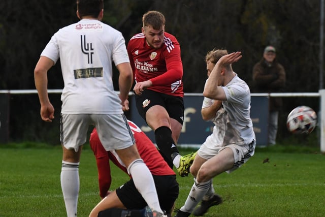 Knaresborough's Luke Jones gets a shot away under pressure from the Albion Sports defence.