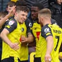 Harrogate Town striker Josh March takes the congratulations of his team-mates after opening the scoring against Bradford City. Pictures: Matt Kirkham