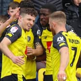 Harrogate Town striker Josh March takes the congratulations of his team-mates after opening the scoring against Bradford City. Pictures: Matt Kirkham