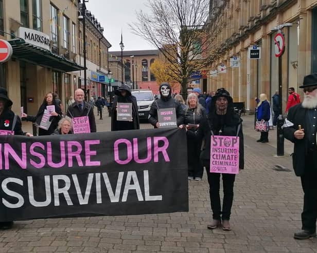 In Harrogate, Extinction Rebellion members staged a funeral procession to protest outside the branch of an insurance firm with banners reading “Insure our Survival" and “Stop Flooding our Homes”.  (Picture contributed)