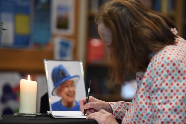 Members of the public sign the book of condolence at St Peter's Church Harrogate.
