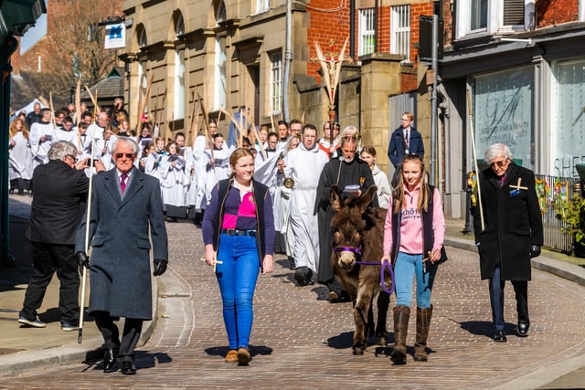 Phoebe Bain, 12, and Liza Potter, 13, with Lily the donkey, aged 19, leading the procession towards Ripon Cathedral