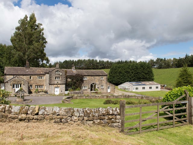 A view across the front of the house and gardens.