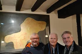 Rock n roll holy grail - Harrogate man Bernard Higgins, middle, in the York pub with what may be the Rolling Stones' autographs on the wall behind him. Also pictured Graham Chalmers, left. (Picture contributed)