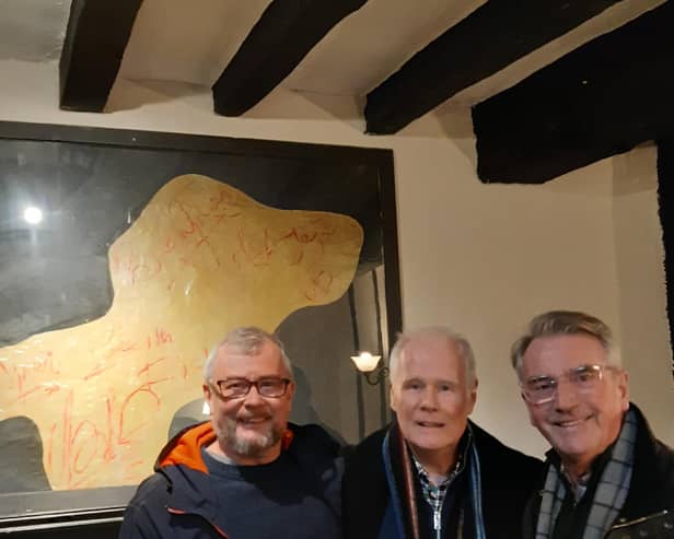 Rock n roll holy grail - Harrogate man Bernard Higgins, middle, in the York pub with what may be the Rolling Stones' autographs on the wall behind him. Also pictured Graham Chalmers, left. (Picture contributed)