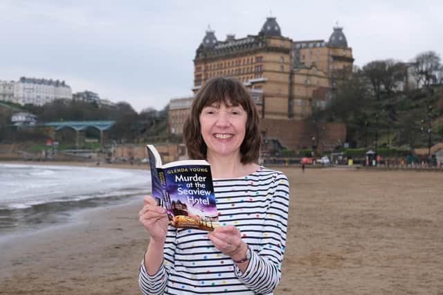 Author Glenda Young in South Bay with one of her cosy crime books which are in Scarborough