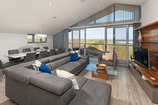 The lounge and dining area is positioned to the rear taking in stunning views via the full height glazing.