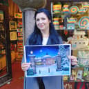 One of Harrogate's emerging artists on the scene, Eve Melia with her painting called "Christmas Eve" outside Harrogate Fair Trade Shop.