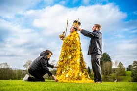 Award-winning Harrogate-based florist Helen James watches as Alex McDonnell from Newby Hall places the King's crown on Rupert North who is wearing the floral coronation cloak her team designed for Harrogate Spring Flower Show. (Picture James Hardisty)