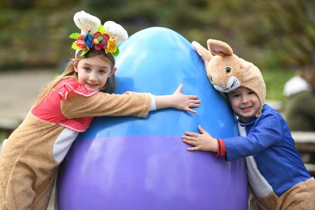 Ava Armitage (aged six) and her brother Oscar Armitage (aged four) give one of the giant eggs a hug