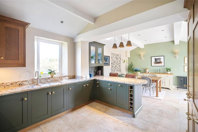 The bespoke kitchen with diner has a breakfast bar, and doors to an outdoor terrace and courtyard.
