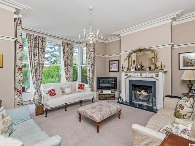 A bright and elegant reception room with feature fireplace.