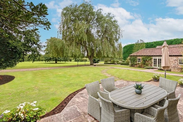 The property's landscaped gardens extend to a two-acre paddock and an eight-acre field.