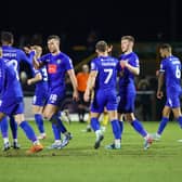 Jack Muldoon takes the congratulations of his Harrogate Town team-mates after opening the scoring during Tuesday night's 2-1 victory at Sutton United. Pictures: Matt Kirkham