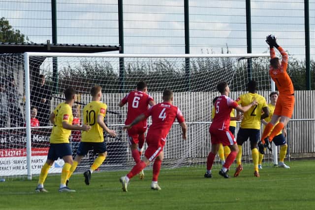 Tadcaster Albion's new goalkeeper, Max Culverwell, climbs highest to claim a cross during Saturday's narrow defeat at Grimsby Borough. Picture: John Clothier