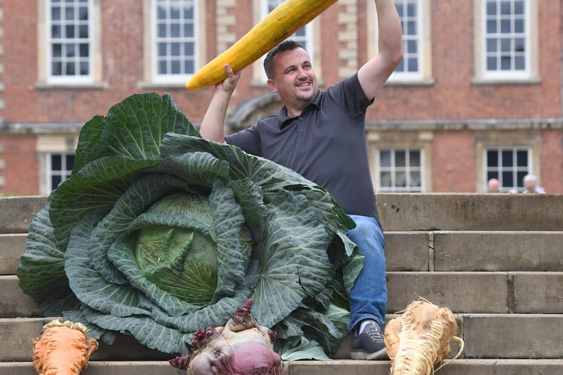 Paul Proud with his prize winning giant cabbage, carrot, parsnip, cucumber and beetroot at the show