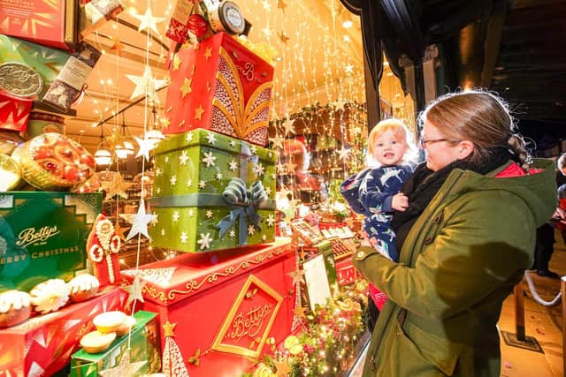 This young family certainly enjoyed Betty's Christmas Window when it was revealed in Harrogate. (Picture contributed)