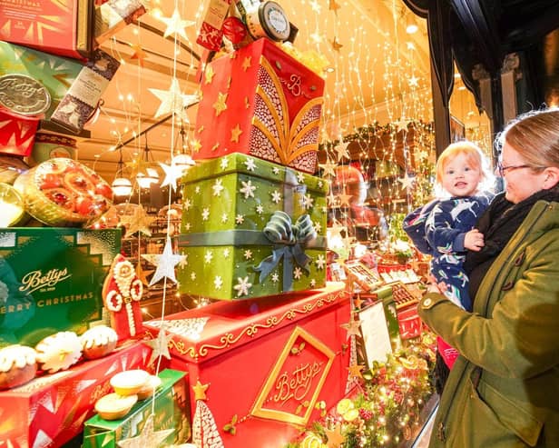 This young family certainly enjoyed Betty's Christmas Window when it was revealed in Harrogate.  (Picture contributed)