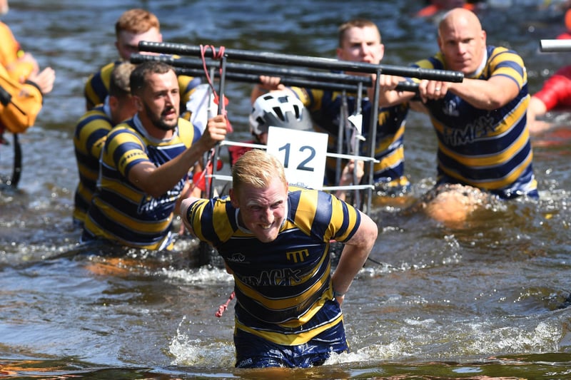 The Knaresborough Rugby Club team making their way through the River Nidd towards the finish line