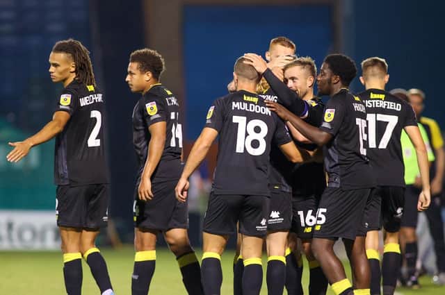 Harrogate Town's players celebrate after taking a 2-0 lead during Tuesday night's League Two clash at Gillingham. Pictures: Matt Kirkham