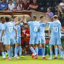 Harrogate Town players celebrate after taking a 49th-minute lead against Lincoln City during Tuesday night's Carabao Cup first round clash at Sincil Bank. Pictures: Matt Kirkham