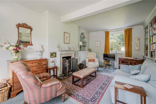 This sitting room has a feature fireplace and built-in bookshelves.