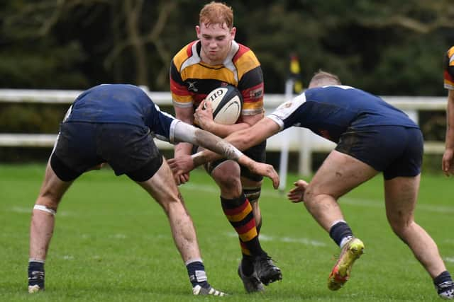 Harrogate's Will Pritchard looks for a route past a pair of visiting defenders.