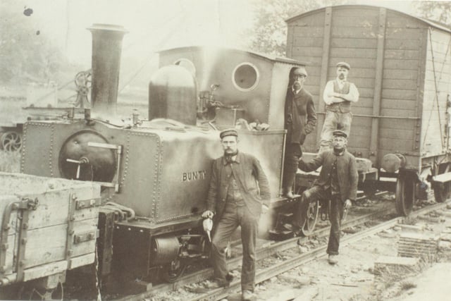 Men posing aside of the construction railway line to Angram.