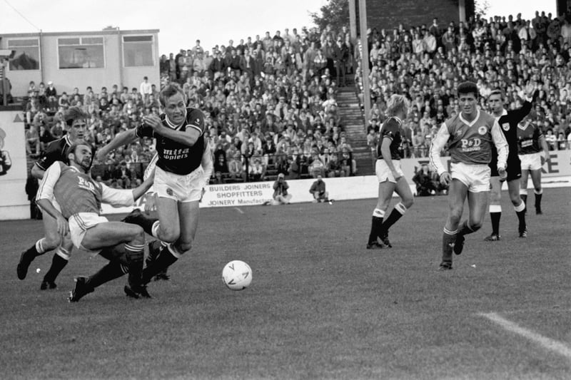 The referee blows for a foul as Hearts captain Walter Kidd is fouled by former team-mate Andy Watson during the Hibs v Hearts Edinburgh derby football match at Easter Road in October 1987.