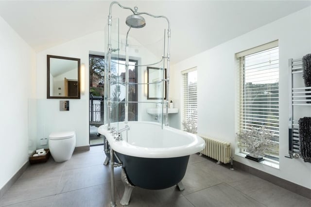 A free standing bath with shower over is the centrepiece of this bathroom within the property.