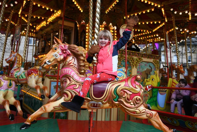 Jessica Phillips (aged six) enjoys a ride on the Victorian carousel in the Crescent Gardens