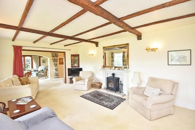 A feature fireplace with stove is a focal point in this comfortable reception room.