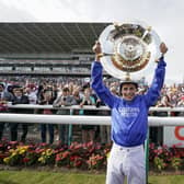 William Buick celebrates with the trophy after riding Hurricane Lane to win The Cazoo St Leger Stakes at Doncaster Racecourse last year. (Photo by Alan Crowhurst/Getty Images)