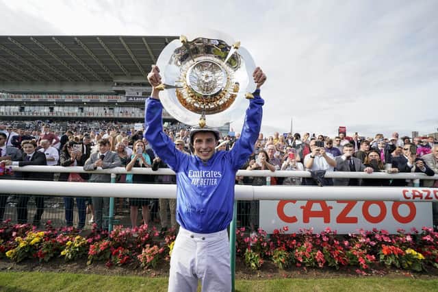 William Buick celebrates with the trophy after riding Hurricane Lane to win The Cazoo St Leger Stakes at Doncaster Racecourse last year. (Photo by Alan Crowhurst/Getty Images)