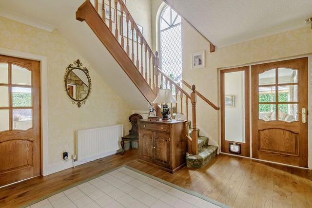 The entrance hall has an oak floor and is overlooked by a gallery landing.